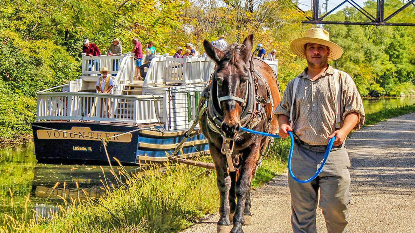 Mule tender leading a mule as it tugs the Canal Boat.